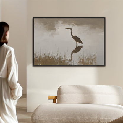 Wade canvas print featuring a heron in serene water with muted earth tones and soft light in a modern living room setting