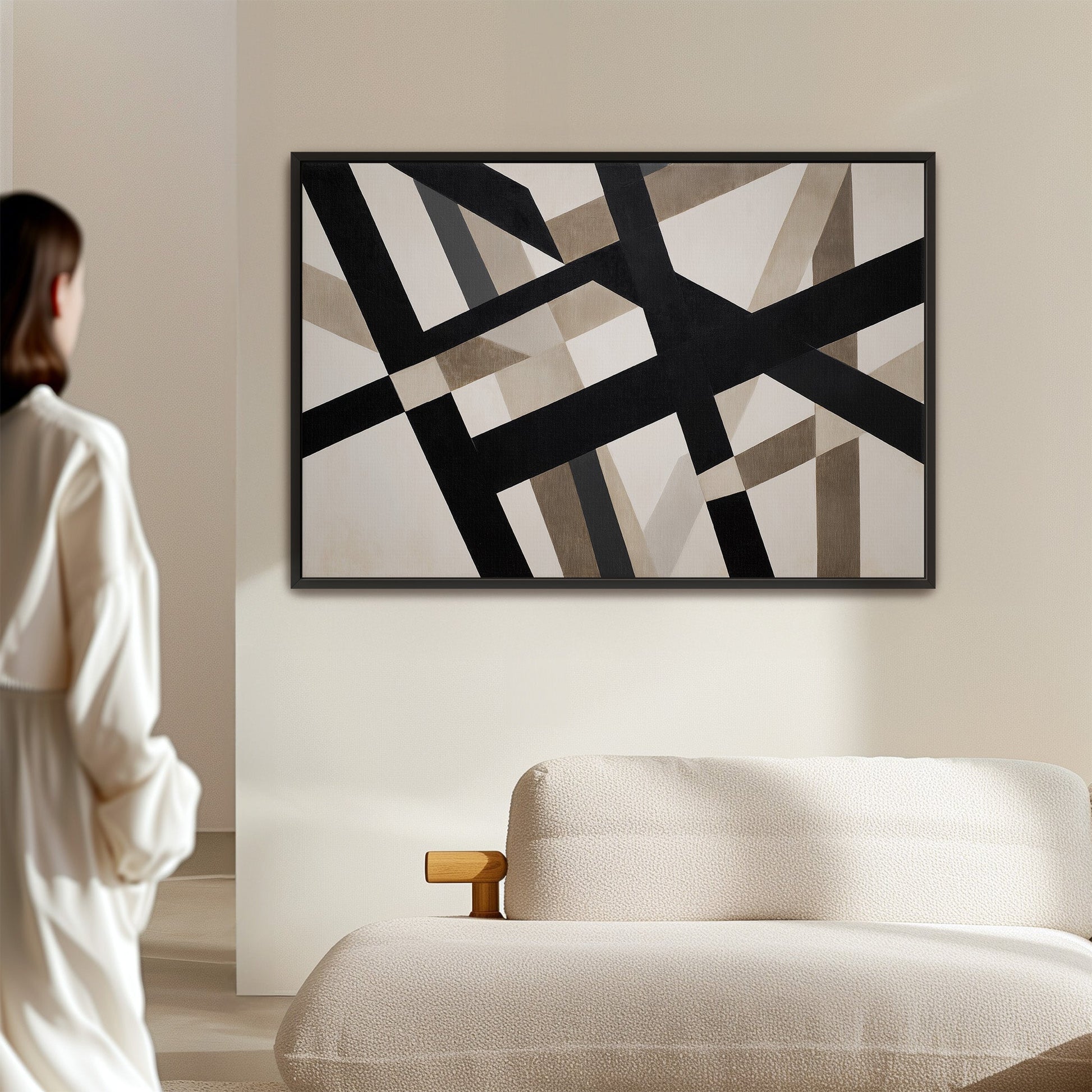 Axis canvas print with bold geometric black and neutral intersecting lines in a minimalist living room setting