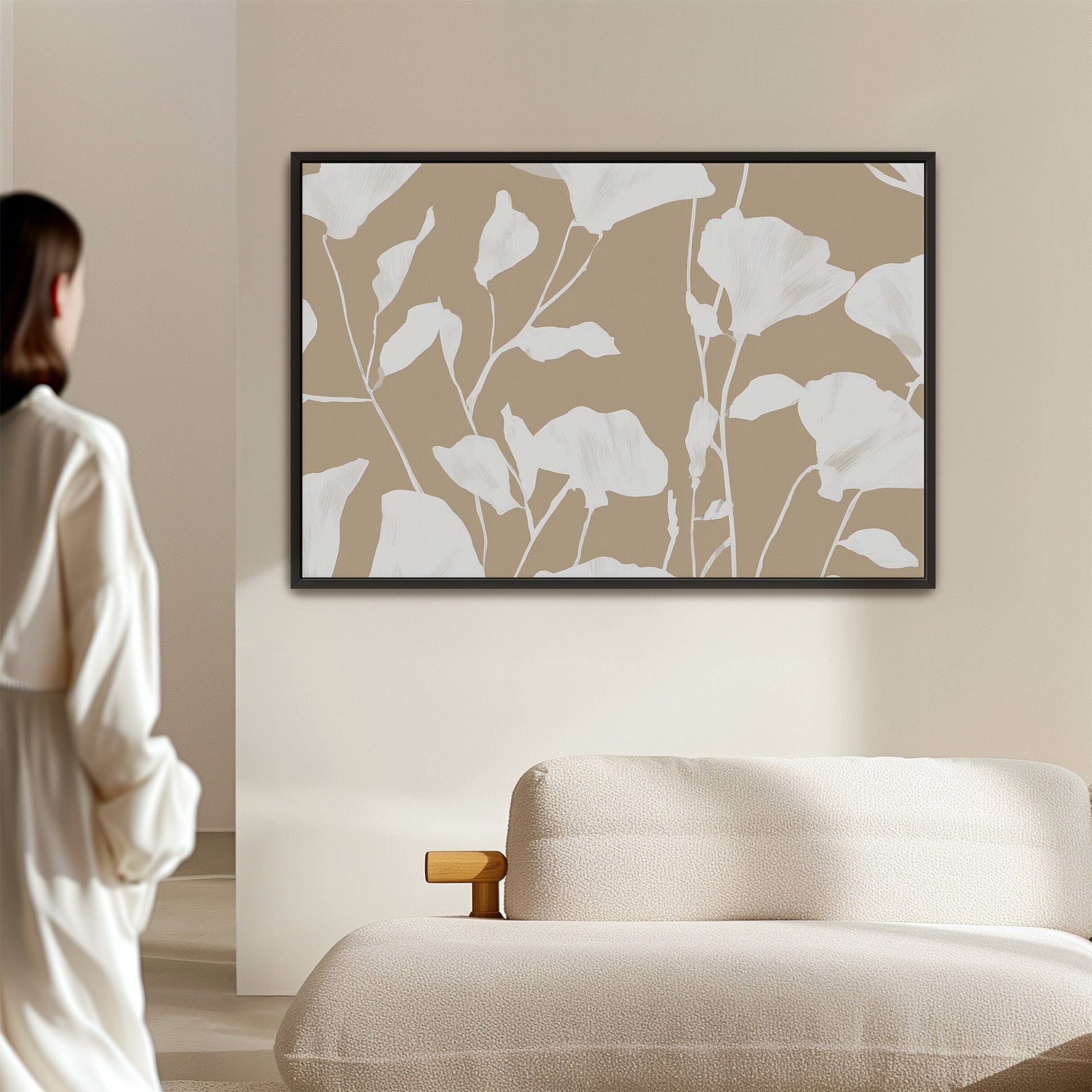 Driftleaf canvas print with white floral silhouettes on beige background in black frame, minimalist wall art.