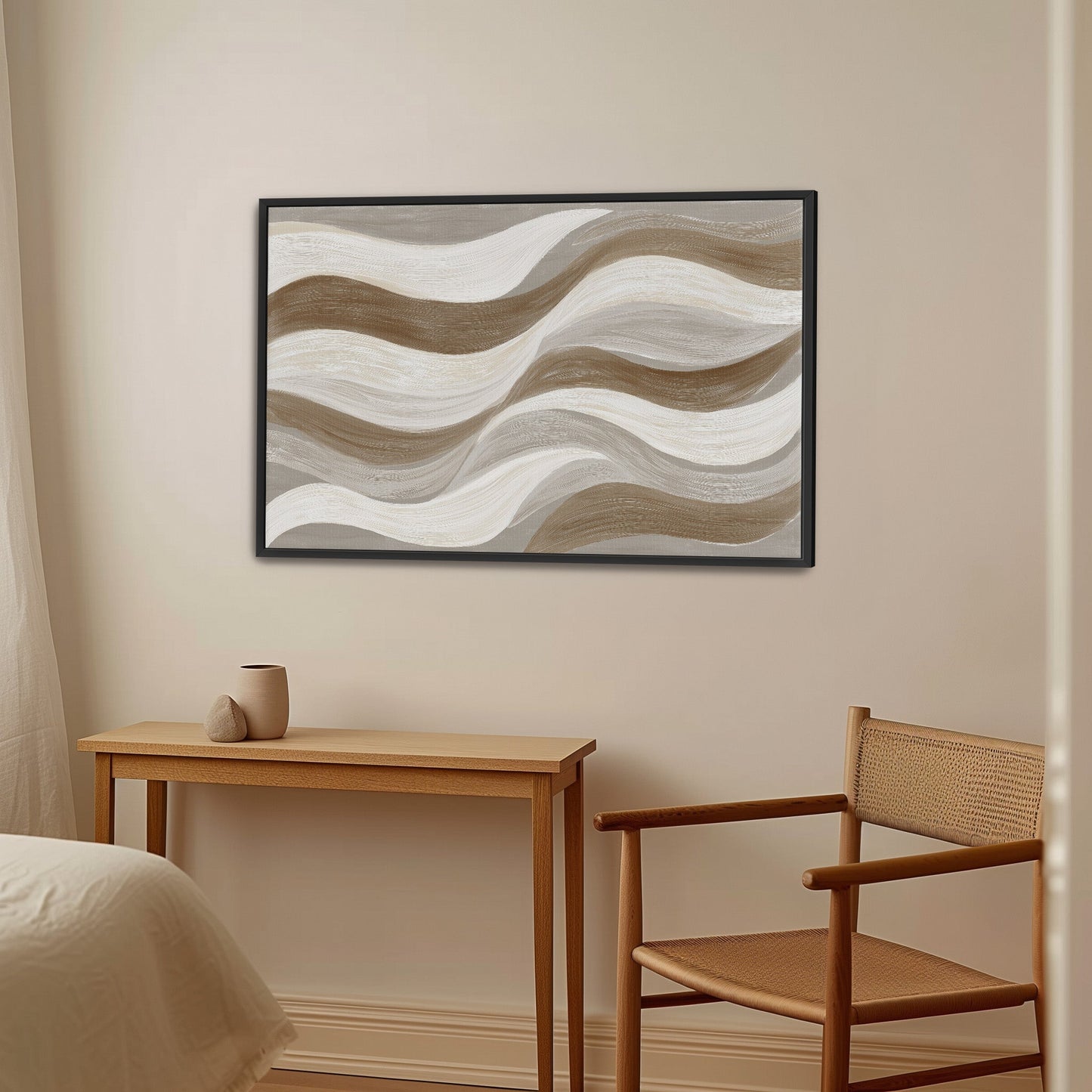Abstract Flux canvas print with cream, taupe, and clay wavy brushstrokes in black frame above wooden desk and chair in neutral room