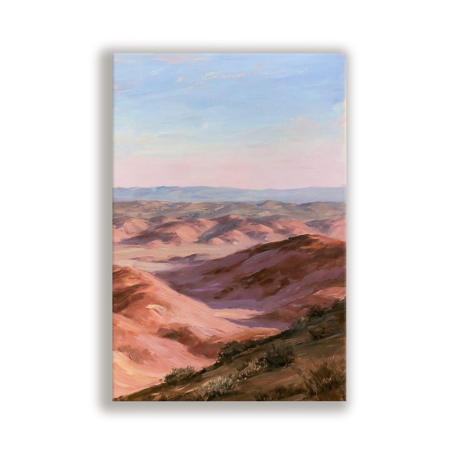 a breathtaking view of a vast, mountainous landscape with rolling hills and valleys under a clear blue sky.