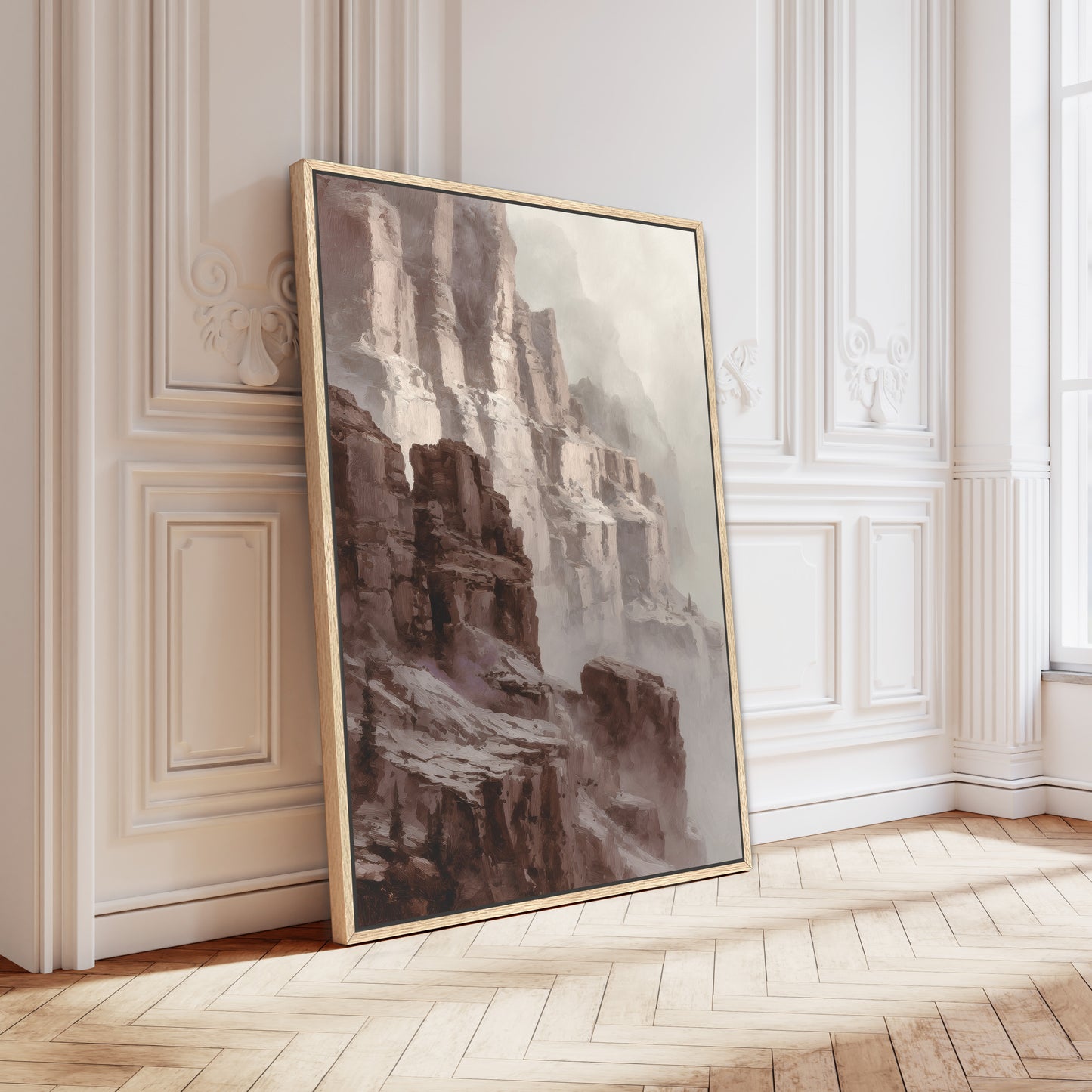 Canyon cliff wall art in a gold frame leaning against ornate wall panels.