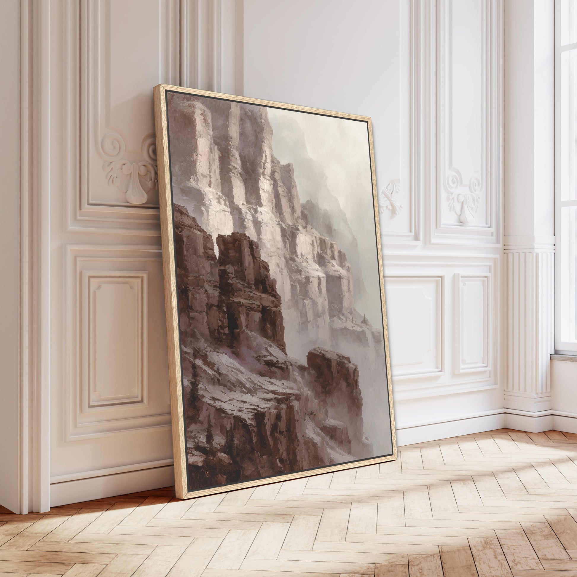 Canyon cliff wall art in a gold frame leaning against ornate wall panels.