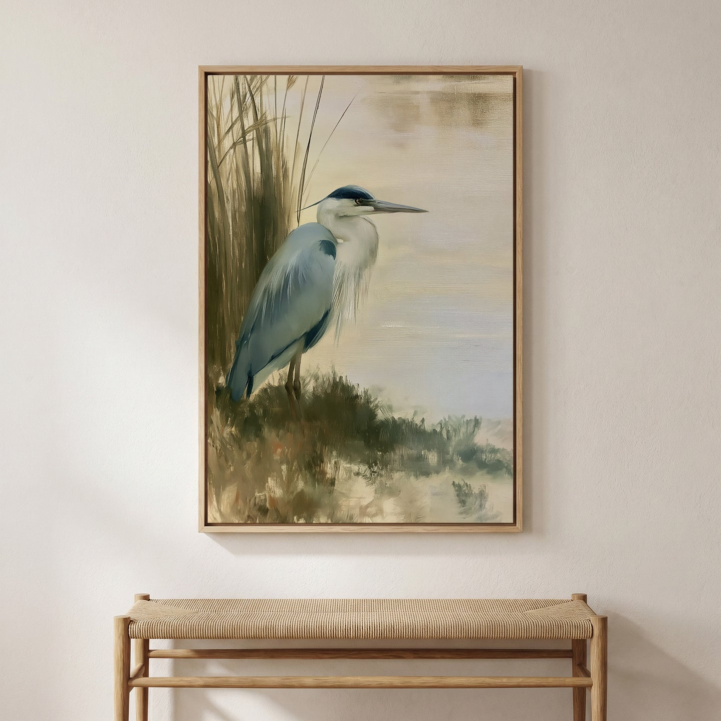 a framed painting of a blue heron standing in tall grass near a body of water.