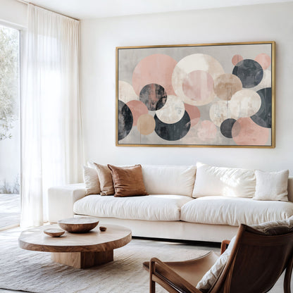 a modern living room with a large abstract painting featuring circles in various shades of pink, blue, and gray hanging on the wall above a white sofa.