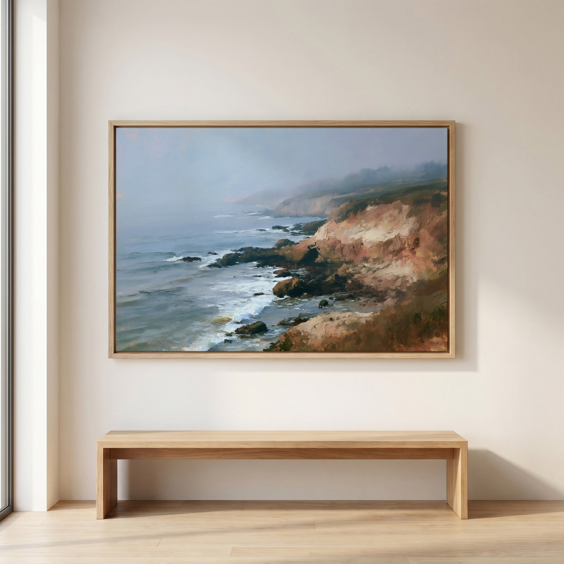a large painting of a rocky coastline with crashing waves hanging on a wall above a wooden bench.