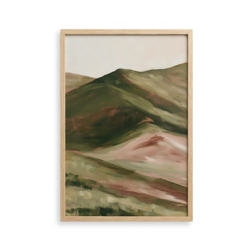 The image is a framed painting depicting a landscape with rolling hills and mountains in shades of green and brown.