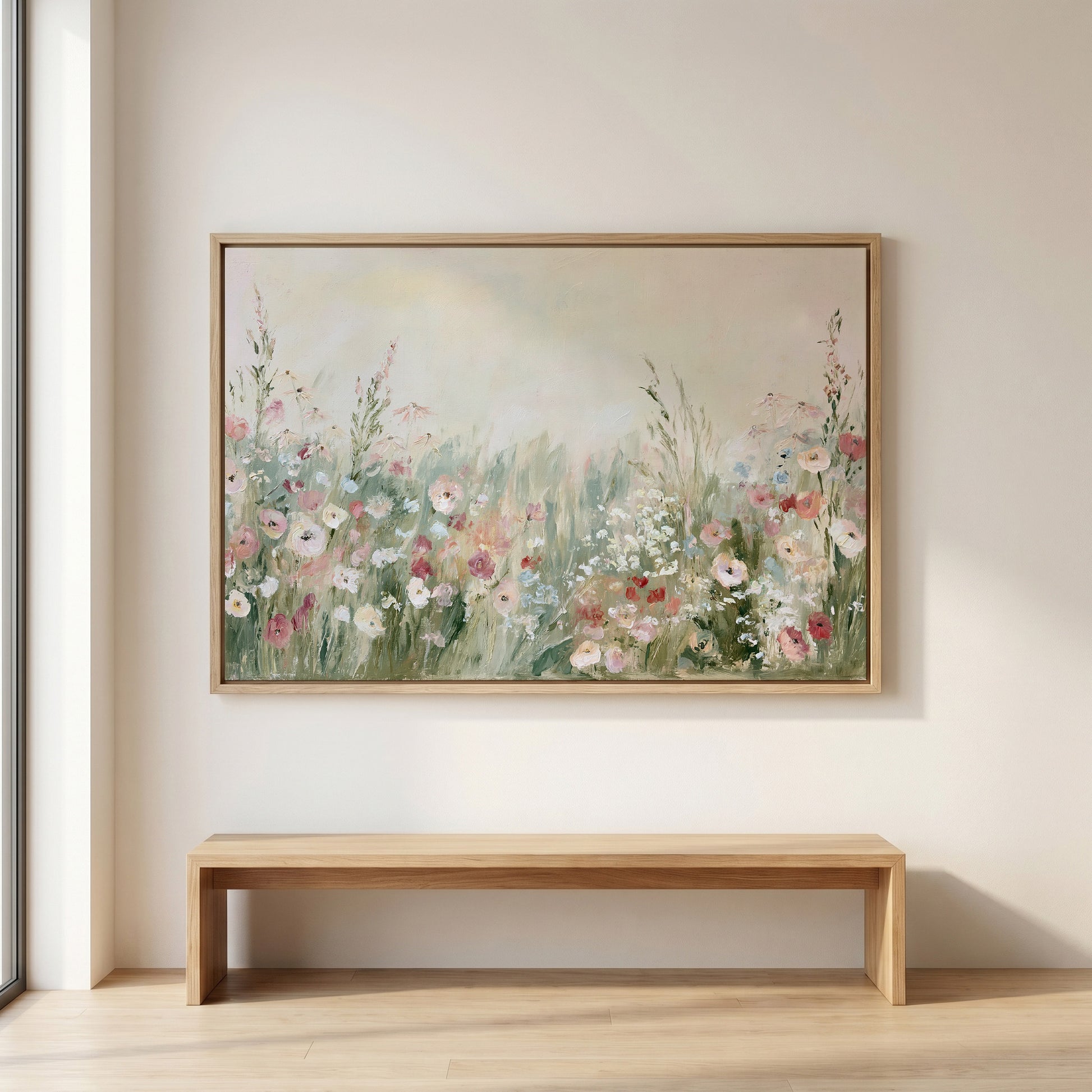 a large painting of a field of flowers hanging on a wall above a wooden bench.
