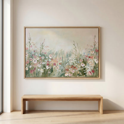 a large painting of a field of flowers hanging on a wall above a wooden bench.