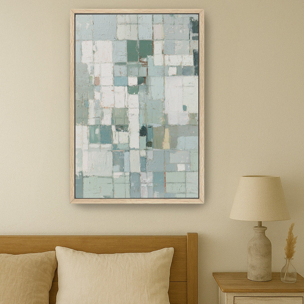 Neutral geometric wall art above bed with beige linens and wooden side table.