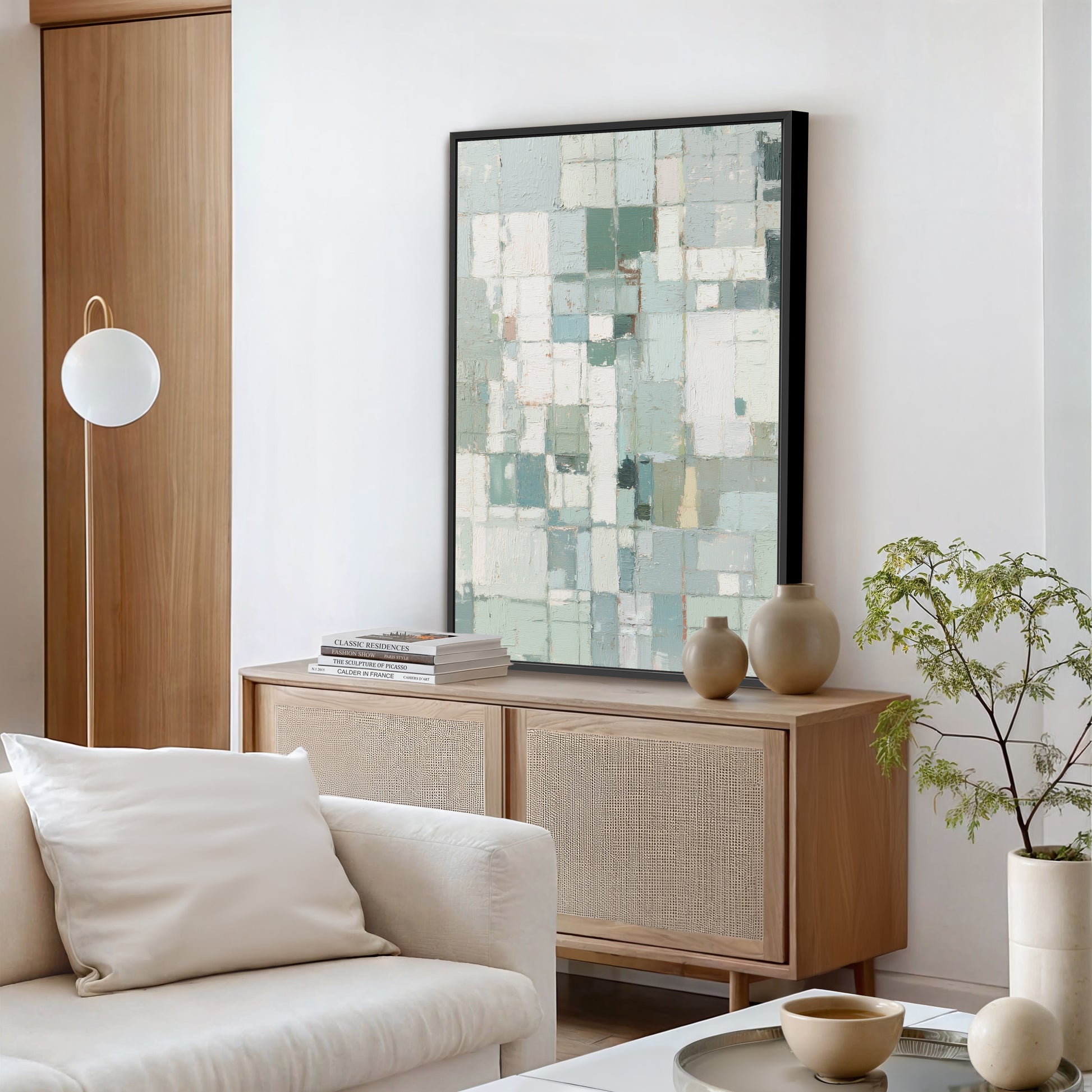 Abstract geometric canvas with bold black frame styled in a modern living room.