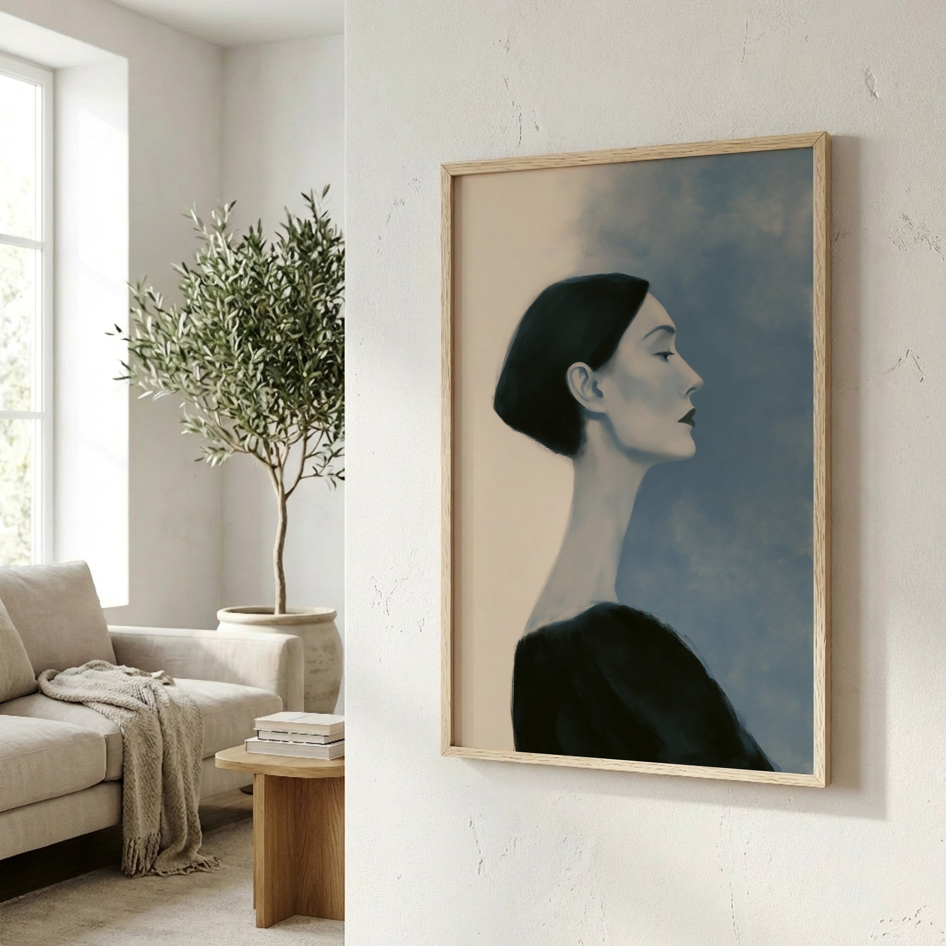 a framed painting of a woman's profile, hanging on a wall in a living room setting.