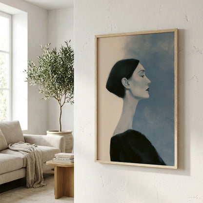 a framed painting of a woman's profile, hanging on a wall in a living room setting.