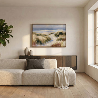 a serene living room with a large window, a beige sofa, a wooden cabinet, and a framed landscape painting hanging on the wall.