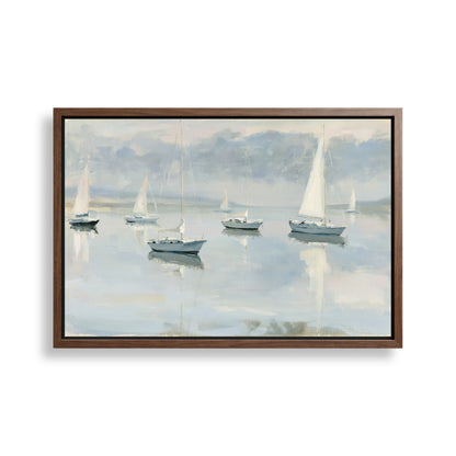 a serene scene of sailboats gently floating on a calm body of water, with a cloudy sky in the background.