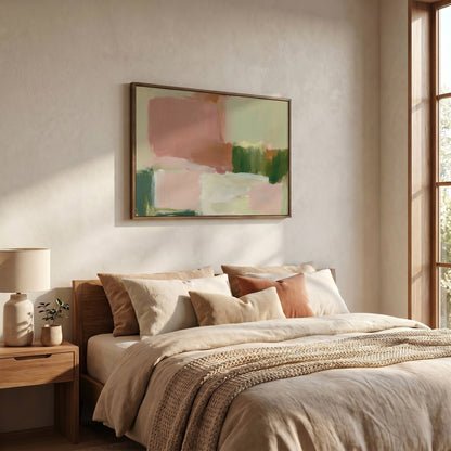 a serene and cozy bedroom with a large bed adorned with beige bedding and a wooden headboard. Above the bed, a framed abstract painting in shades of pink and green adds a touch of artistic flair to the room. The room is well-lit, with natural light streaming in from a window on the right side, creating a warm and inviting atmosphere.