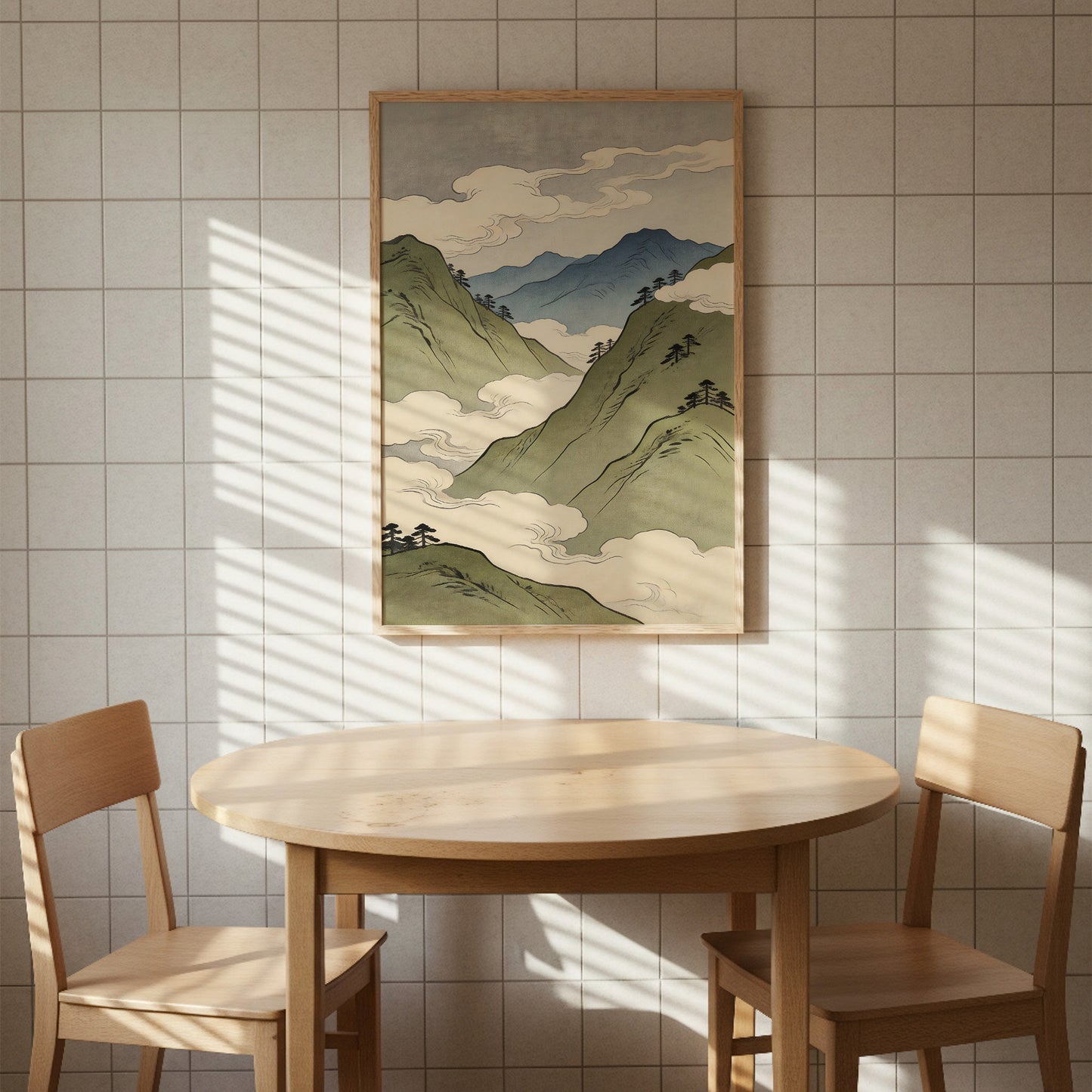 Asian mountain landscape art print with misty peaks and clouds in natural wood frame above round dining table