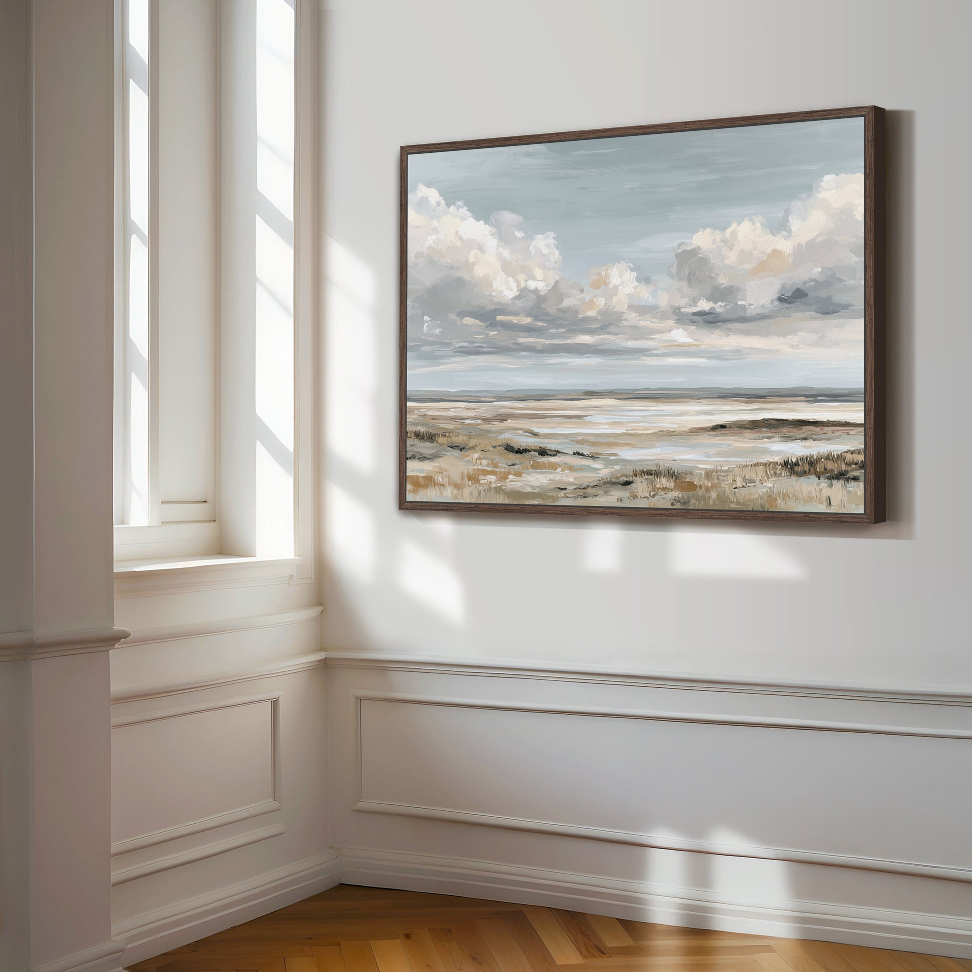 a large landscape painting hanging on a white wall, depicting a serene scene of a cloudy sky over a grassy field.