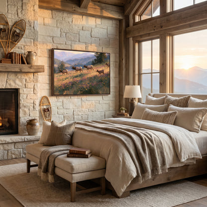 a cozy bedroom with a large bed, a fireplace, and a painting of deer in a field. The room has a rustic, cabin-like atmosphere with wooden beams and stone walls.