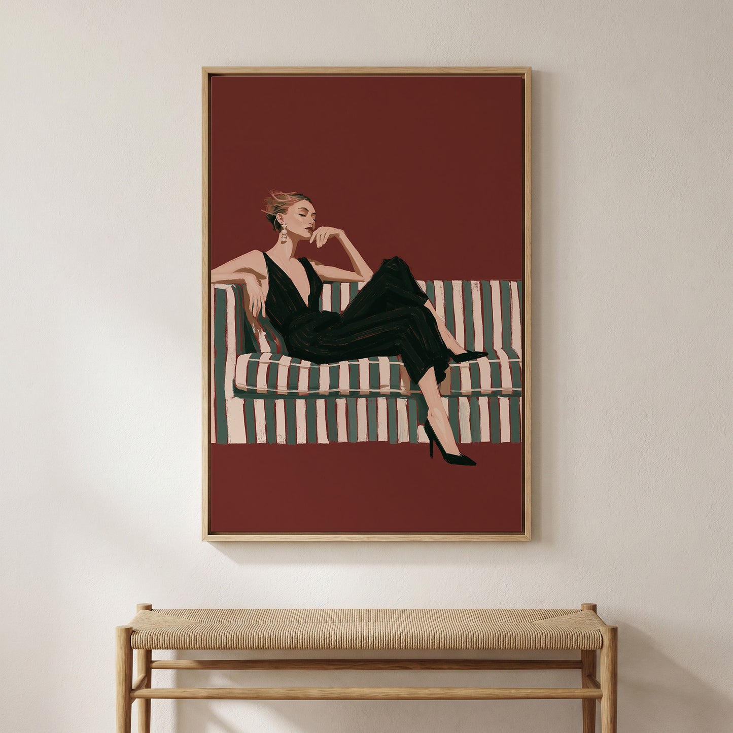 A framed illustration of a woman in a black dress sitting on a striped couch.