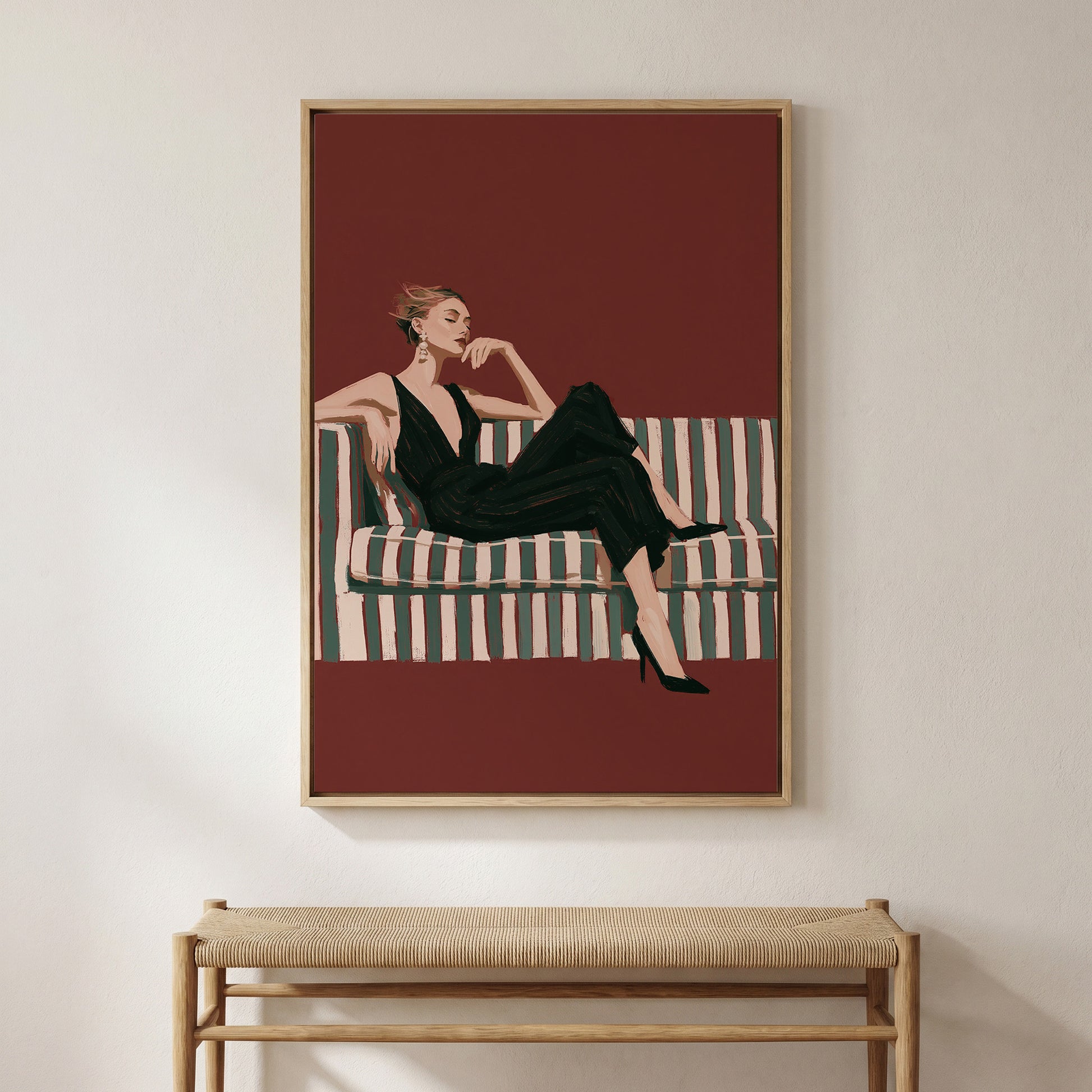 A framed illustration of a woman in a black dress sitting on a striped couch.