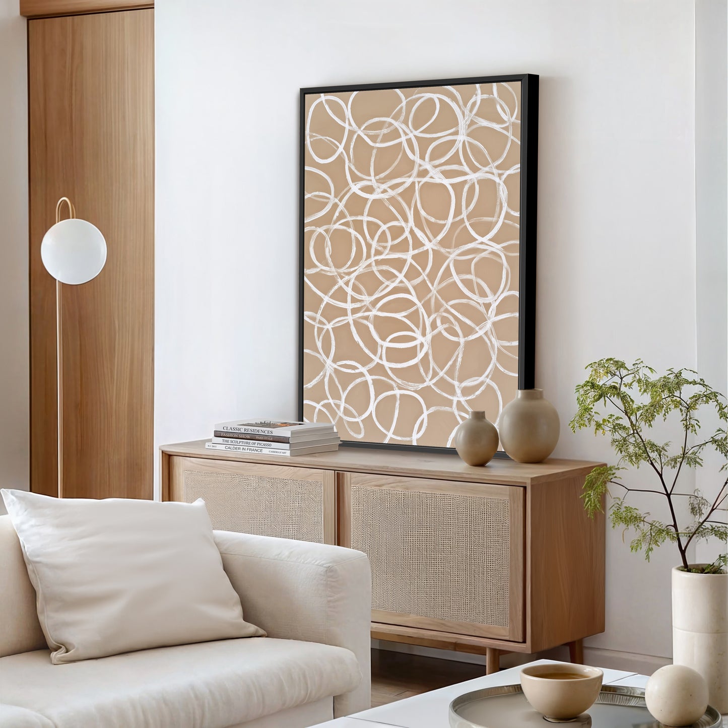 a modern living room with a white sofa, a wooden cabinet, a large abstract painting, and a potted plant.