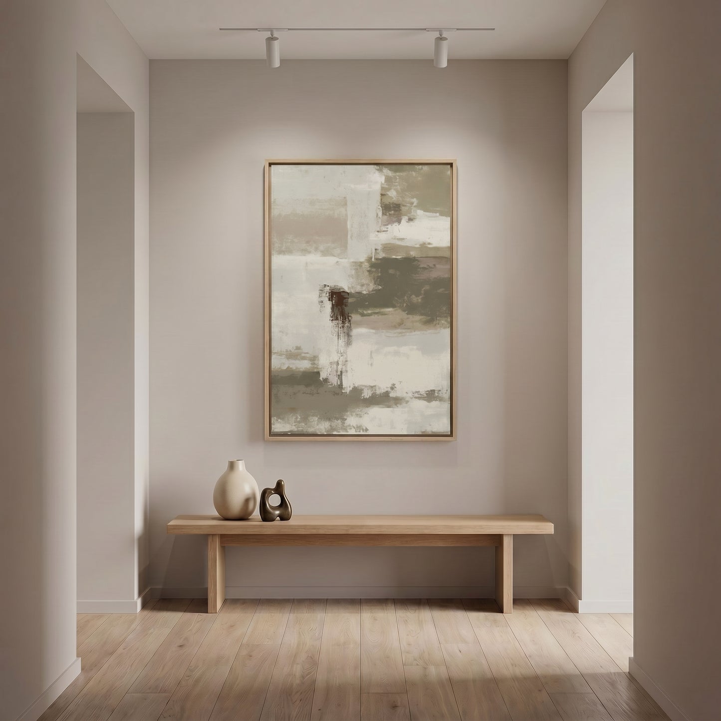 a minimalist interior design with a large abstract painting hanging on the wall above a wooden bench. The painting is predominantly gray and white, creating a calm and serene atmosphere in the room. The wooden bench provides a comfortable seating area, and a small sculpture is placed on the bench, adding an artistic touch to the space. The overall design is clean and uncluttered, with a focus on the artwork and the natural materials of the bench and sculpture.