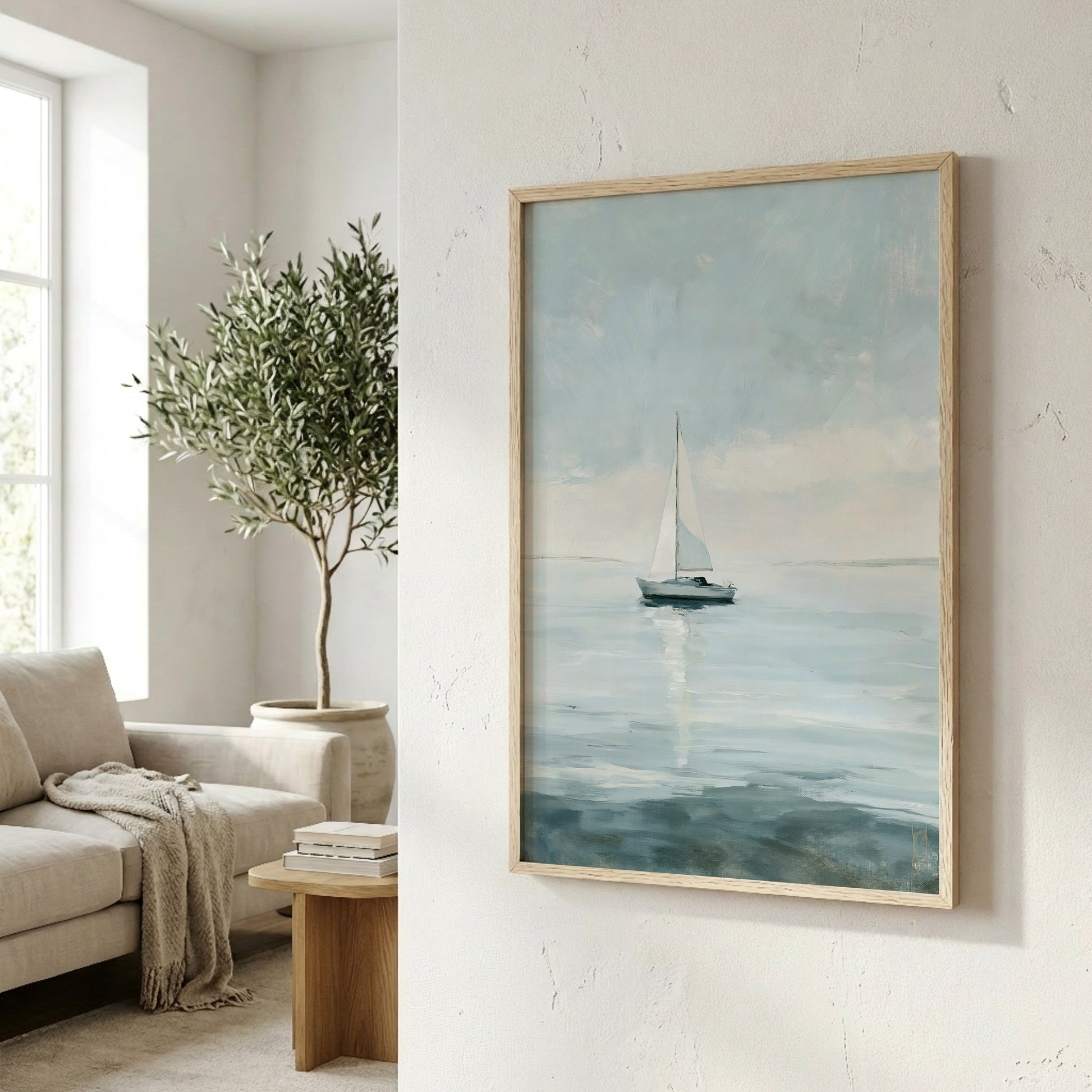 a serene indoor setting with a framed painting of a sailboat on the ocean, a potted plant, a couch, and a wooden side table.