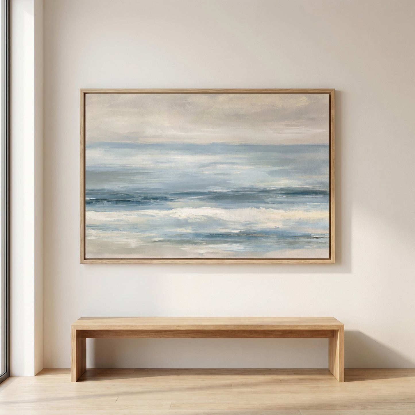 a large painting of a serene ocean scene hanging on a wall above a wooden bench.