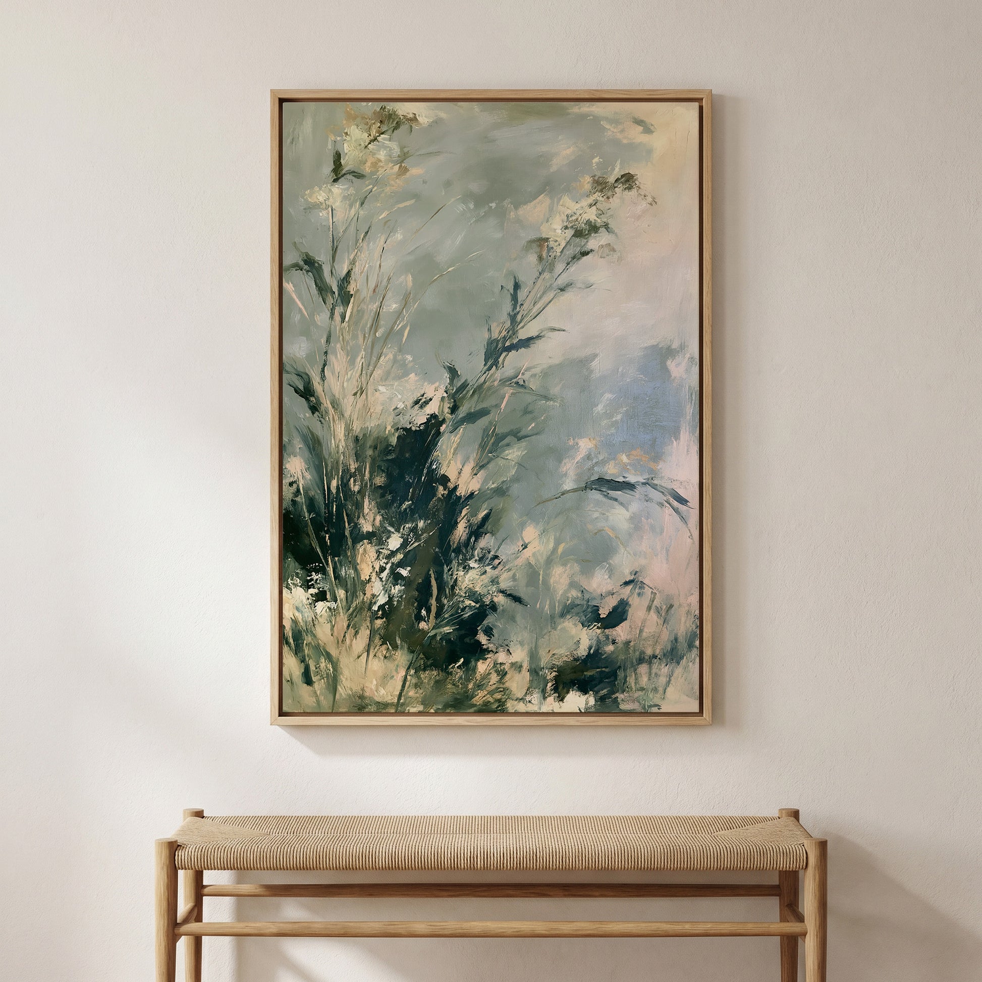 a large, framed painting of a lush, green landscape hanging on a wall above a wooden bench.