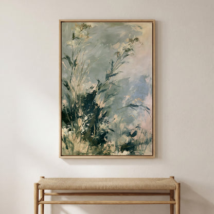 a large, framed painting of a lush, green landscape hanging on a wall above a wooden bench.