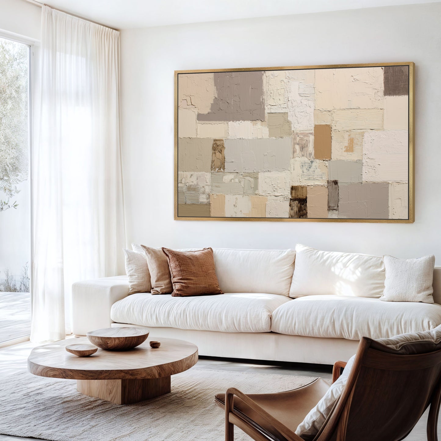 a modern living room with a large abstract painting on the wall, a white sofa, a wooden coffee table, and a brown leather armchair.