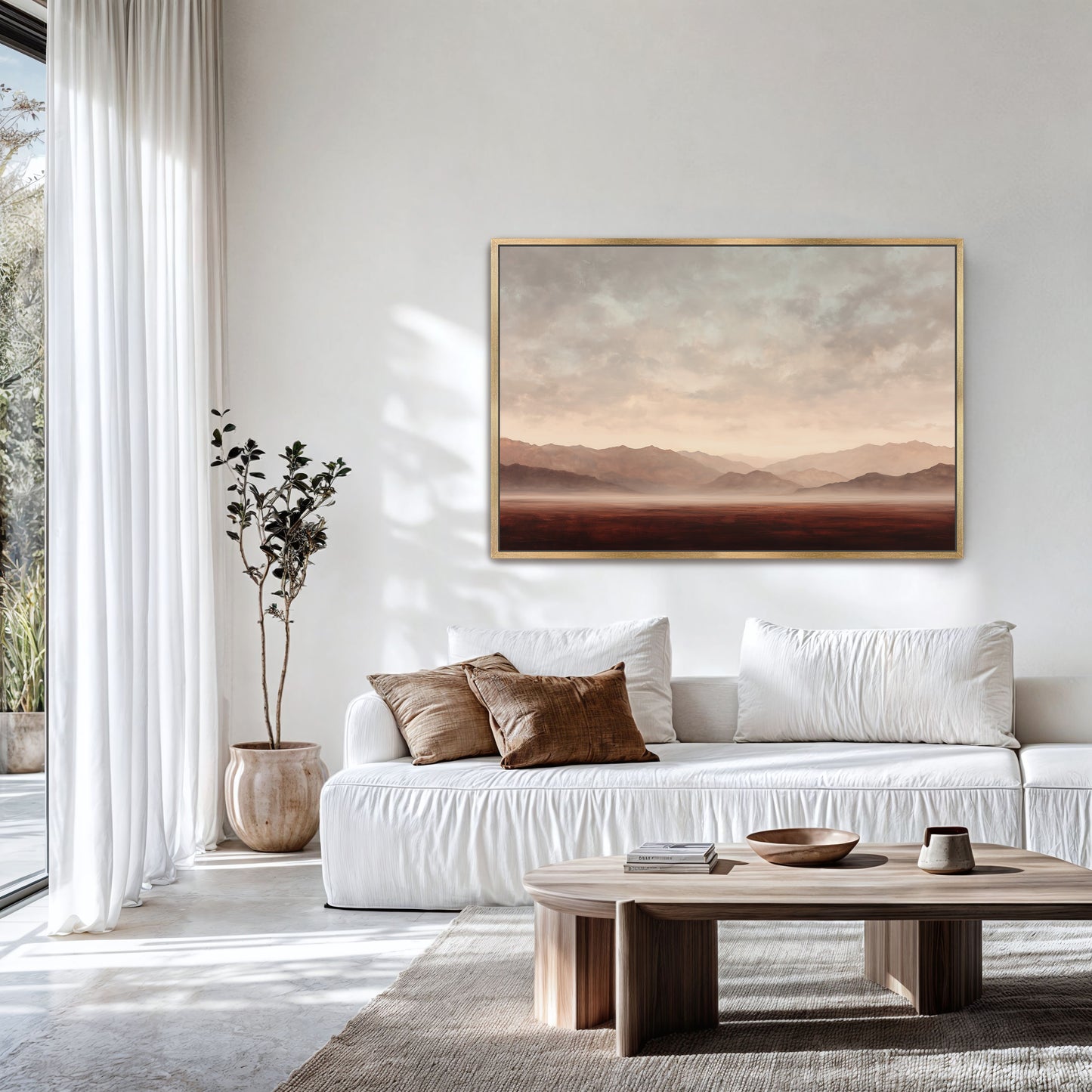 a modern living room with a large window, white sofa, and a wooden coffee table. A framed landscape painting hangs on the wall above the sofa, and a potted plant is placed next to the window.