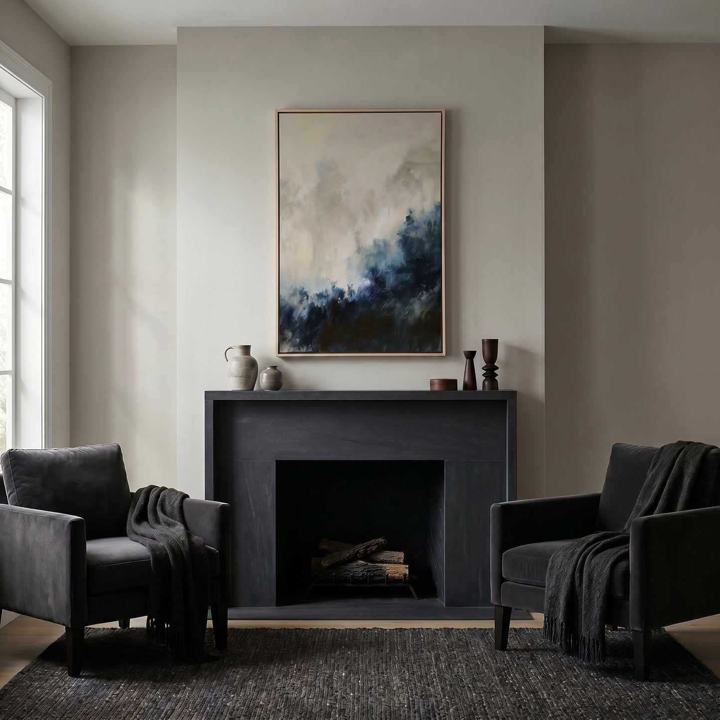 a cozy living room with a fireplace, two black armchairs, and a large abstract painting hanging above the fireplace.