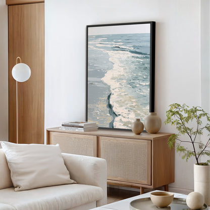 a serene living room with a large painting of a tranquil ocean scene hanging on the wall above a wooden cabinet. The room is furnished with a white sofa, a coffee table, and a potted plant, creating a cozy and inviting atmosphere.