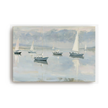 a serene scene of sailboats gently floating on a calm body of water, with a cloudy sky in the background.