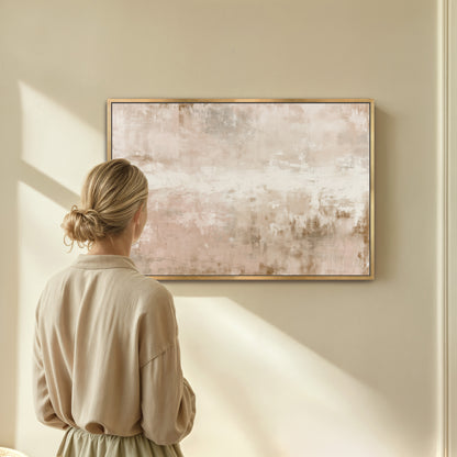 A woman in a beige dress stands in front of a large abstract painting on a wall, gazing at it.