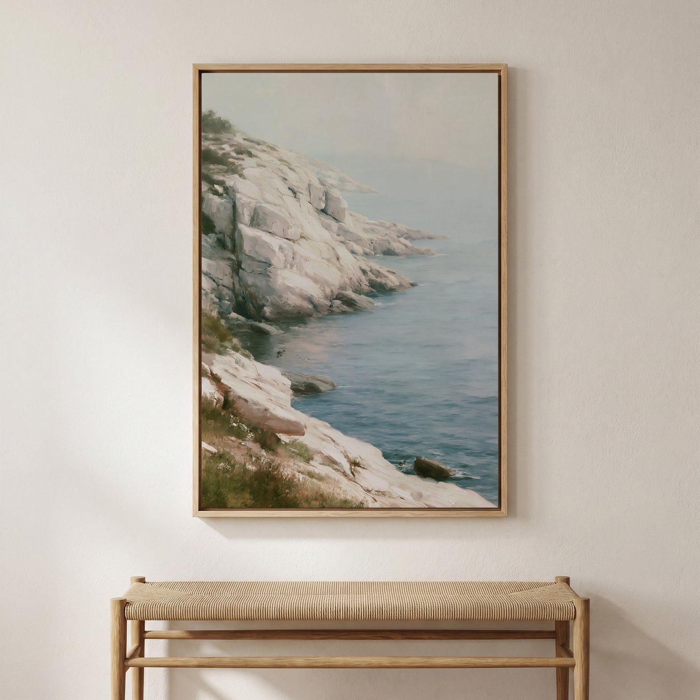 a large framed painting of a rocky coastline with a view of the ocean.