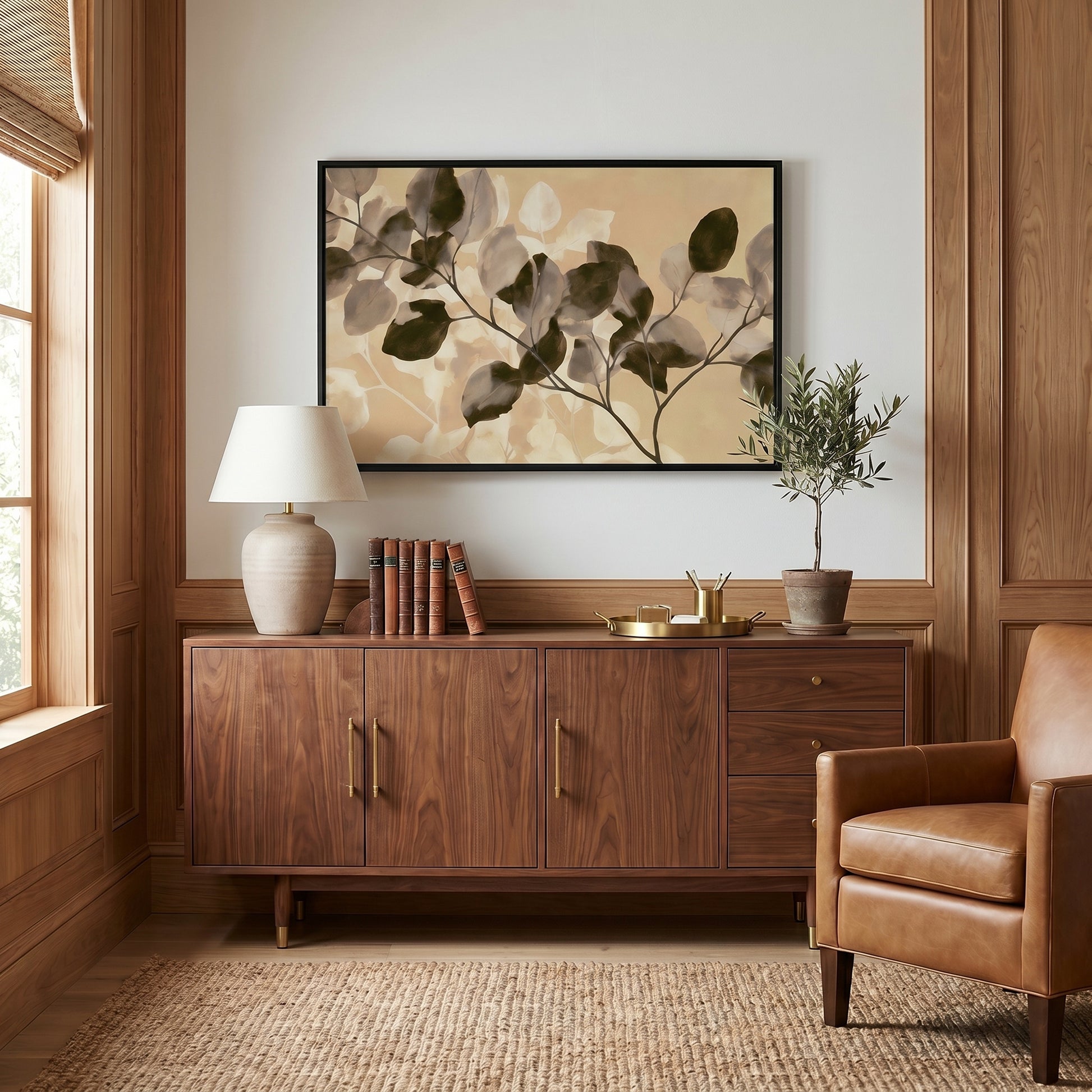 a cozy living room with a large wooden cabinet, a leather armchair, and a framed artwork featuring a plant on the wall.