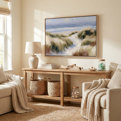a cozy living room with a large painting of a beach scene hanging on the wall. The room is furnished with a sofa, a wooden console table, and a rug. The painting adds a touch of nature and serenity to the space, creating a warm and inviting atmosphere.