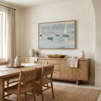 a serene dining room with a large painting of sailboats on the wall, a wooden dining table with chairs, and a wooden cabinet or sideboard.