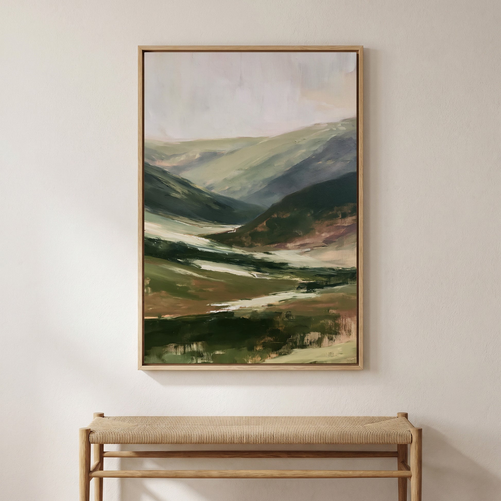 a large landscape painting hanging on a wall above a wooden bench.