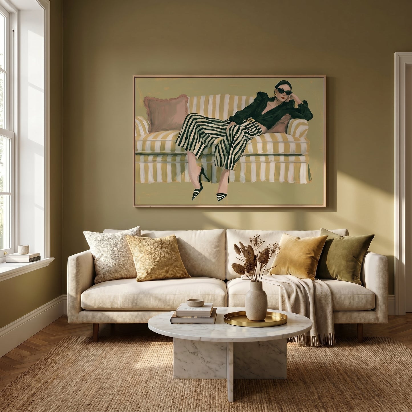 a cozy living room with a large painting of a woman lounging on a striped couch, which is positioned in front of a window. The room is furnished with a white sofa, a round coffee table, and a vase of dried flowers. The overall color scheme of the room is neutral, with a green wall and beige carpet.