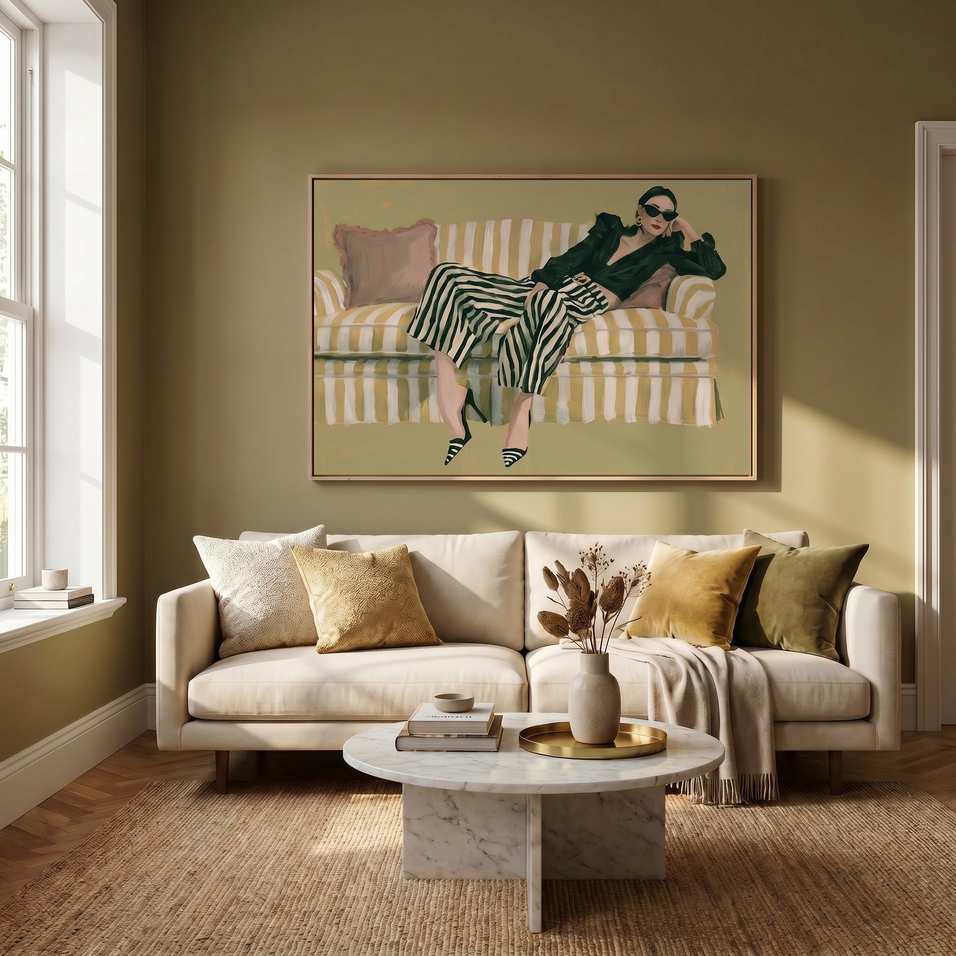 a cozy living room with a large painting of a woman lounging on a striped couch, which is positioned in front of a window. The room is furnished with a white sofa, a round coffee table, and a vase of dried flowers. The overall color scheme of the room is neutral, with a green wall and beige carpet.