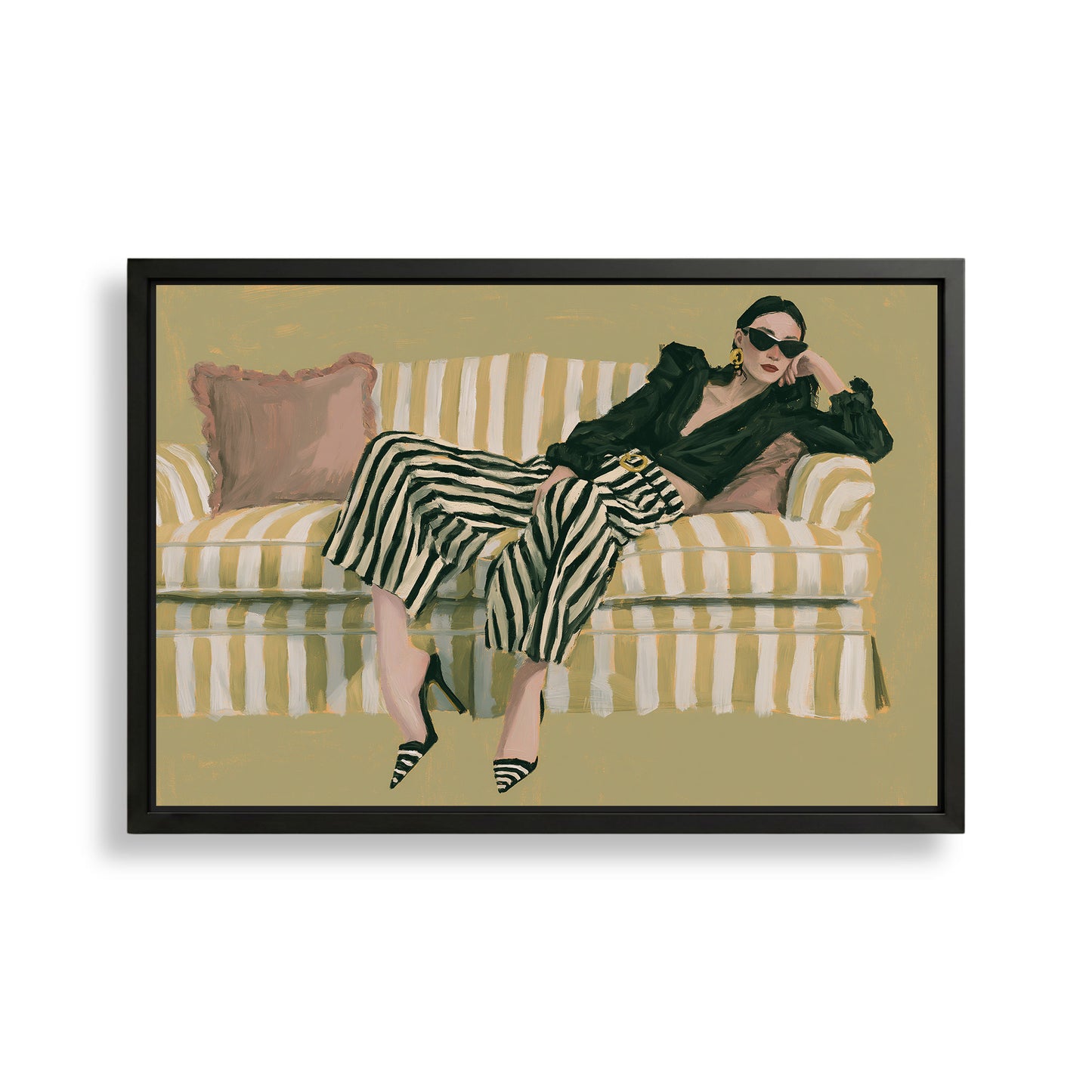 A woman wearing a black jacket and striped pants is sitting on a striped couch, with a pink pillow on the couch.