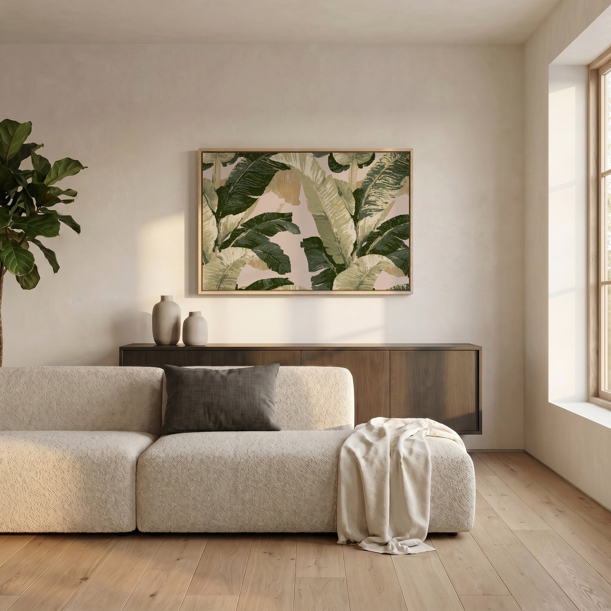 a modern living room with a large window, a white sofa, a wooden cabinet, and a framed artwork featuring a tropical leaf pattern on the wall.