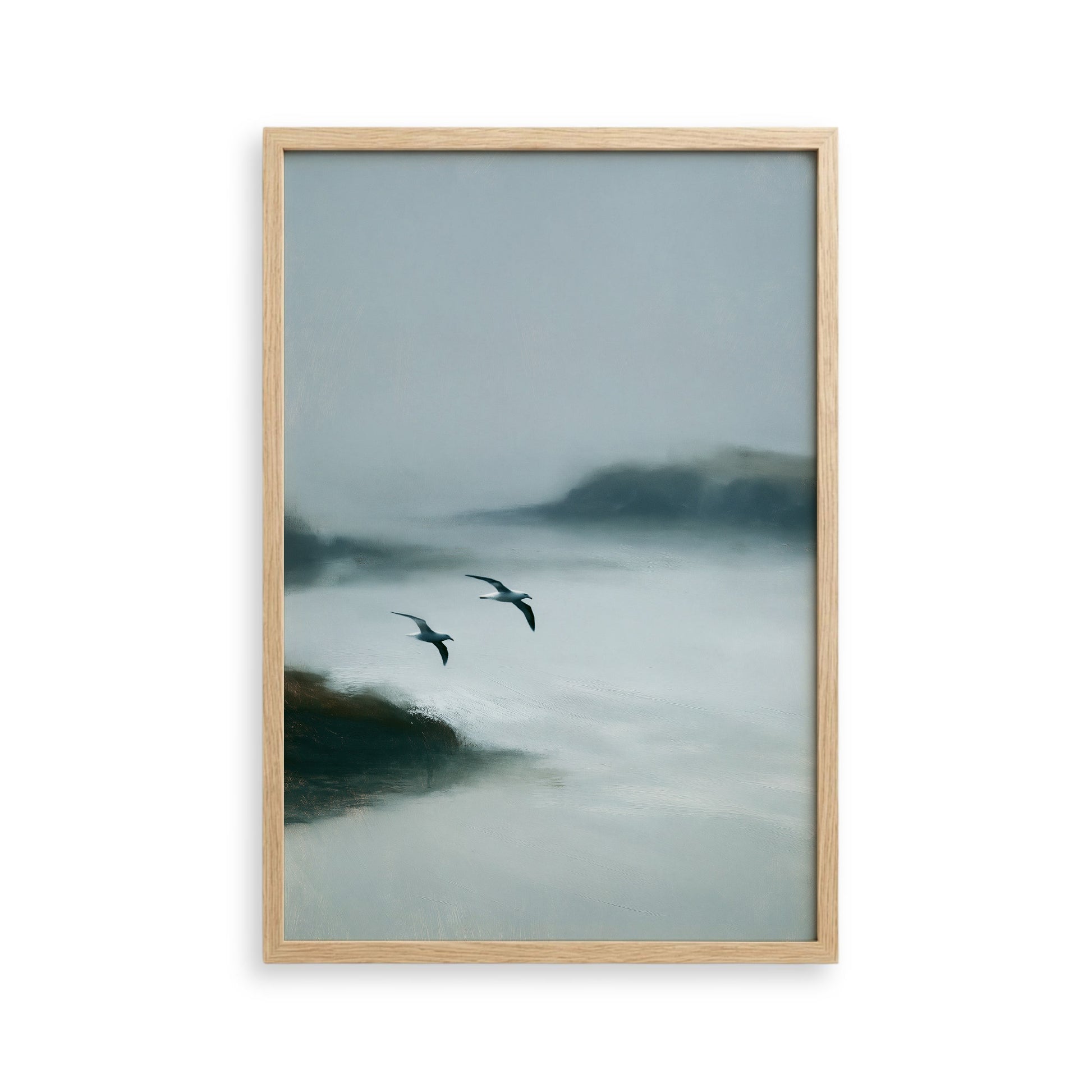two birds flying over a misty, foggy landscape.