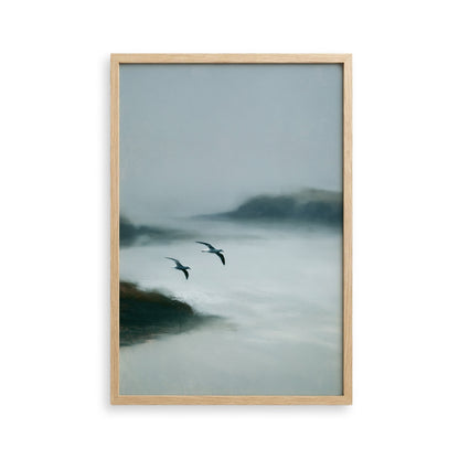 two birds flying over a misty, foggy landscape.