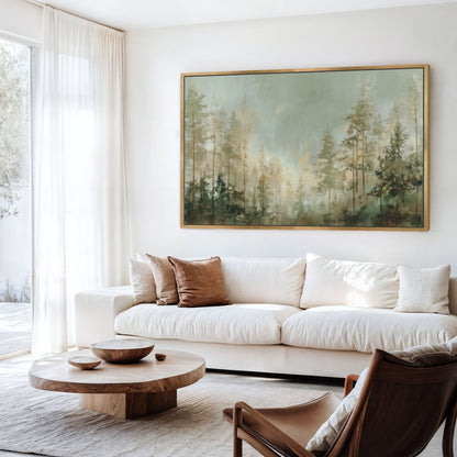 a serene living room with a large painting of a forest scene hanging on the wall. The room is furnished with a white sofa, a wooden coffee table, and a brown leather armchair. The overall decor has a modern and minimalist aesthetic.