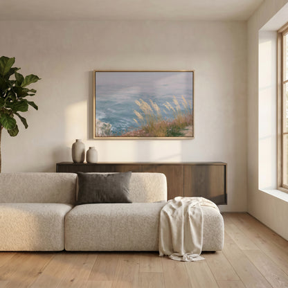 a serene living room with a large window, a white sofa, a wooden cabinet, and a framed landscape painting of a beach scene.